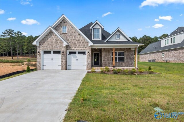 craftsman-style house featuring a garage, a front lawn, and cooling unit