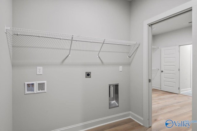 laundry area with hookup for a washing machine, hardwood / wood-style flooring, and electric dryer hookup