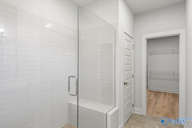 bathroom featuring hardwood / wood-style floors and an enclosed shower