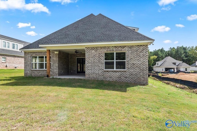 back of house with ceiling fan, a lawn, and a patio