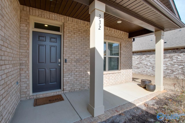 entrance to property with brick siding