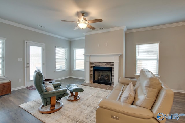 living room featuring ornamental molding, plenty of natural light, and wood finished floors