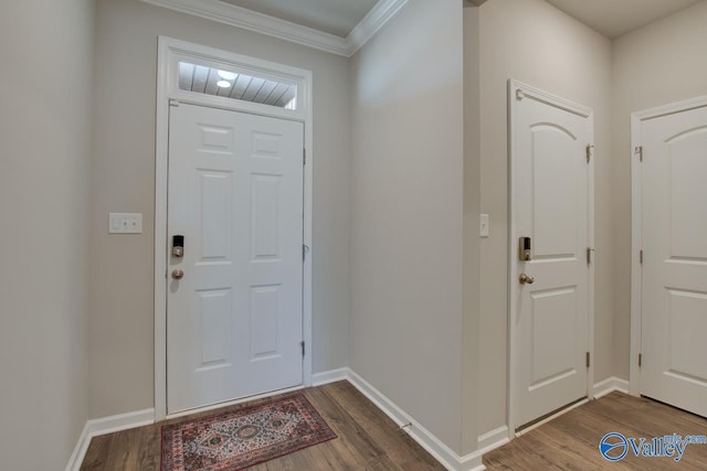 foyer with ornamental molding, dark wood-style flooring, and baseboards