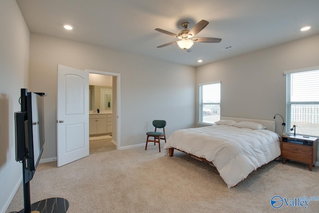 bedroom featuring multiple windows, light carpet, and baseboards