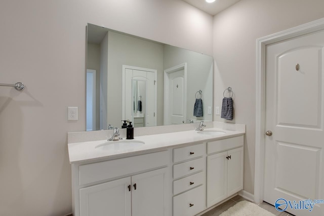 bathroom featuring a sink and double vanity