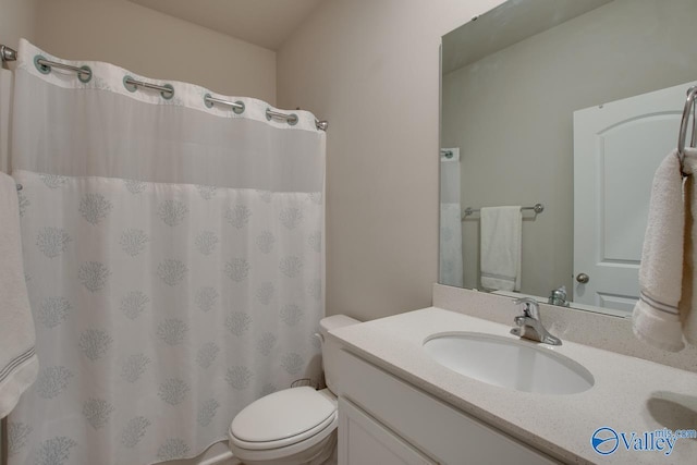 bathroom featuring toilet, a shower with shower curtain, and vanity