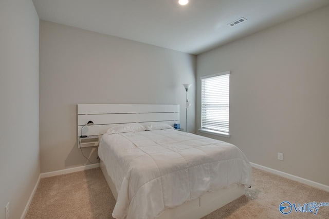 bedroom with carpet floors, baseboards, and visible vents