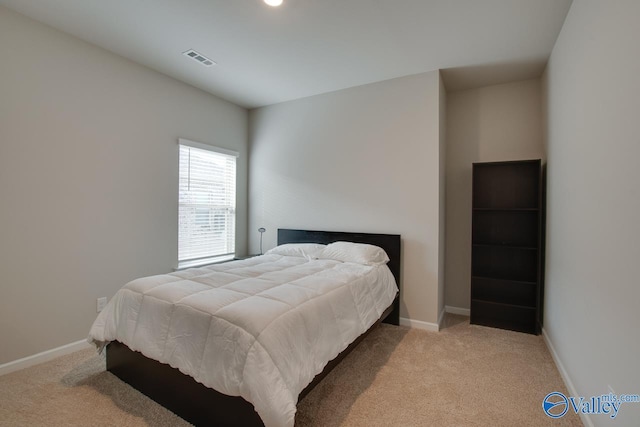 bedroom with carpet, visible vents, and baseboards