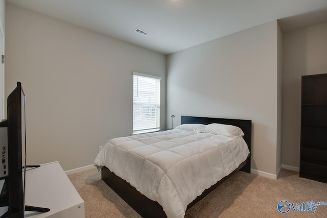 carpeted bedroom featuring visible vents and baseboards