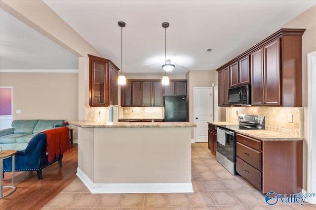 kitchen featuring black appliances, decorative backsplash, light stone countertops, and a peninsula