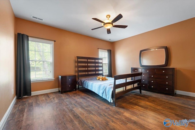bedroom featuring wood finished floors, baseboards, and ceiling fan
