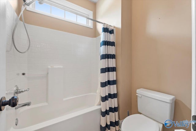bathroom with shower / tub combo and toilet