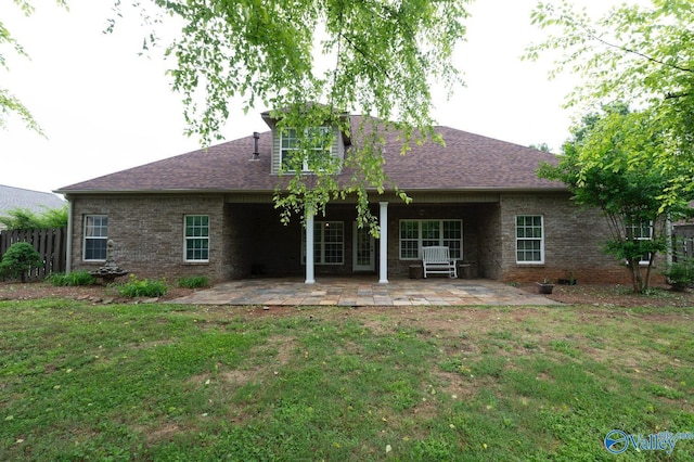 back of house featuring a patio and a shingled roof