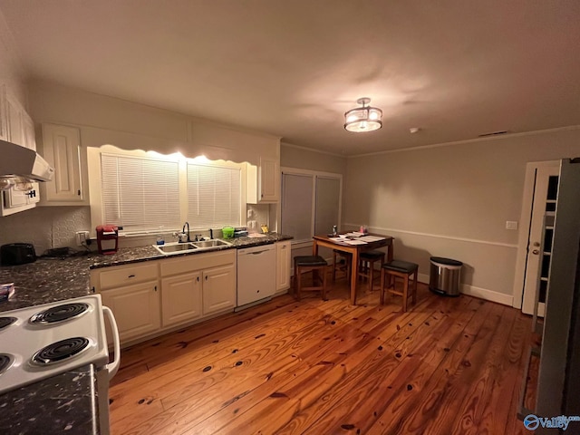 kitchen with white appliances, light hardwood / wood-style floors, white cabinetry, and sink