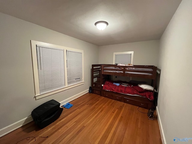 bedroom with hardwood / wood-style flooring