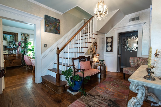 staircase featuring ornamental molding, wood finished floors, visible vents, and a notable chandelier