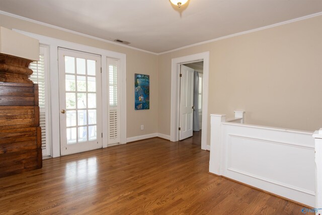 bedroom with dark wood-type flooring, ceiling fan, crown molding, and multiple closets