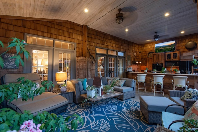 view of patio / terrace with exterior bar, outdoor lounge area, and a ceiling fan