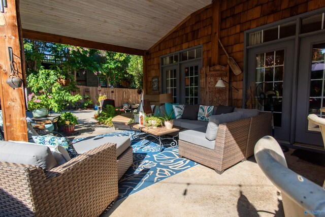 view of patio / terrace featuring fence, an outdoor living space, and french doors