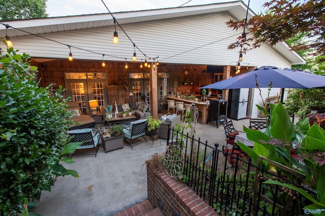 view of patio / terrace featuring an outdoor hangout area, an outdoor bar, and french doors