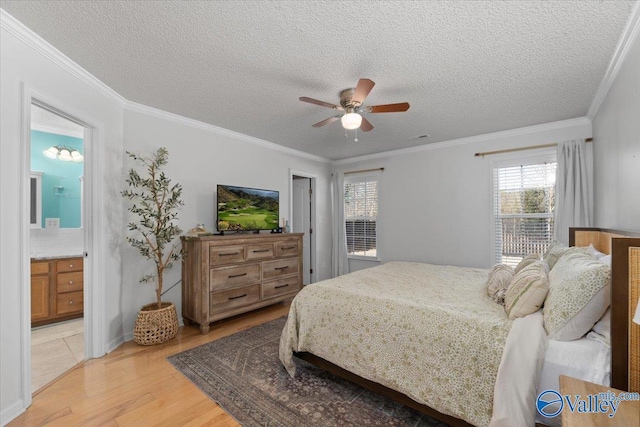 bedroom featuring connected bathroom, crown molding, a textured ceiling, light wood-type flooring, and ceiling fan