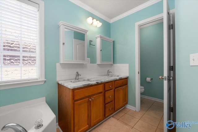 bathroom featuring tile patterned flooring, vanity, ornamental molding, decorative backsplash, and toilet