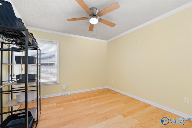 unfurnished bedroom with ceiling fan, ornamental molding, light hardwood / wood-style floors, and a textured ceiling