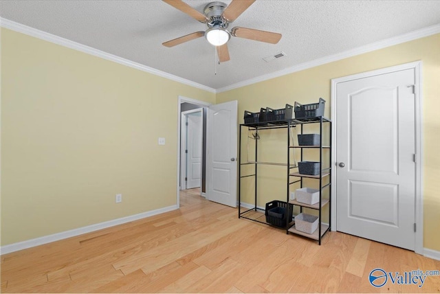 bedroom featuring crown molding, ceiling fan, light hardwood / wood-style floors, and a textured ceiling