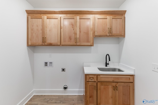 laundry area with hookup for a washing machine, a sink, baseboards, cabinet space, and electric dryer hookup