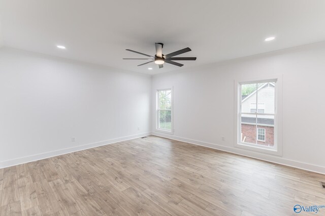 empty room featuring baseboards, light wood finished floors, and recessed lighting