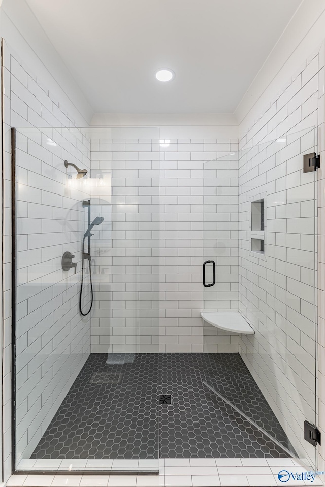 bathroom with a stall shower and ornamental molding