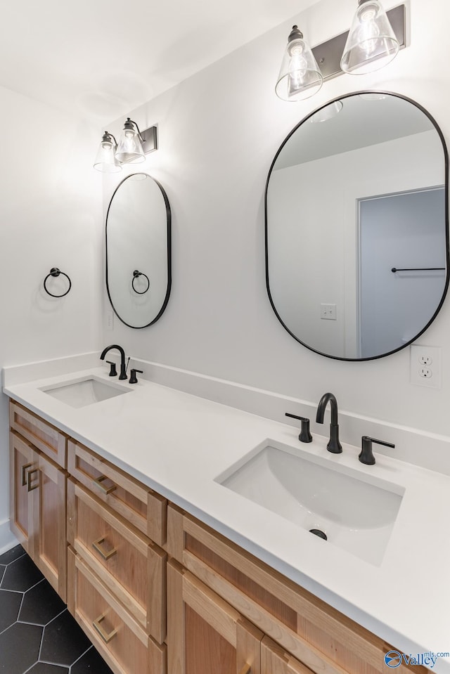 bathroom featuring double vanity, a sink, and tile patterned floors