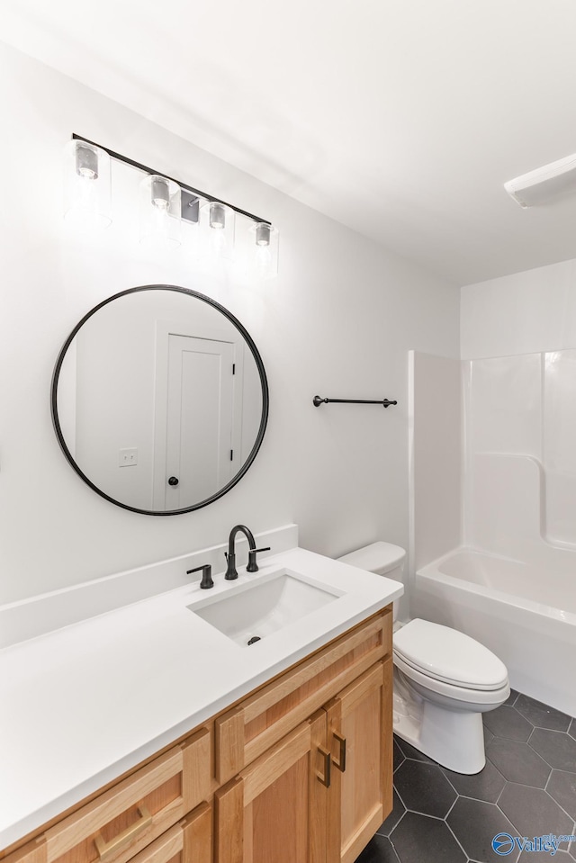 full bathroom featuring bathtub / shower combination, vanity, toilet, and tile patterned floors