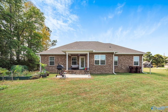 back of property with a patio and a yard