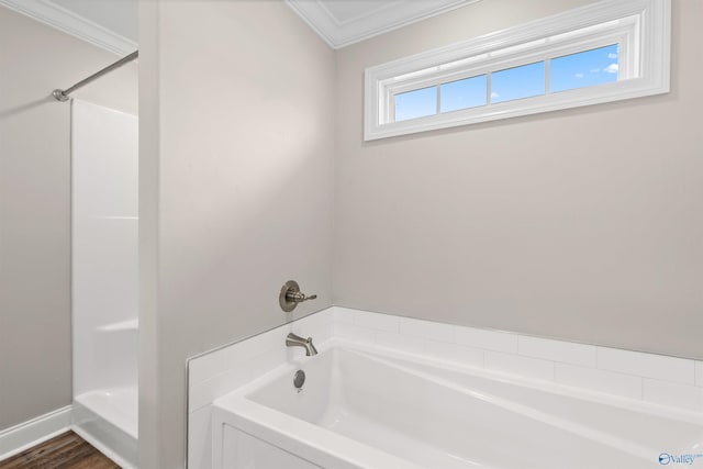 bathroom with ornamental molding and a bathtub