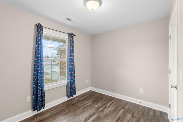 empty room featuring dark hardwood / wood-style flooring