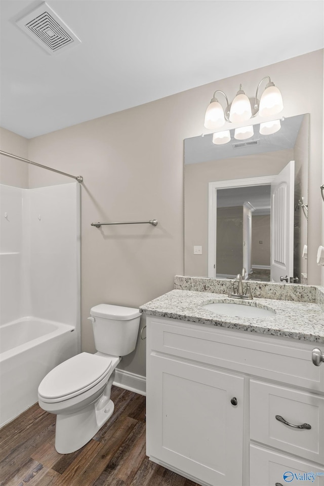 full bathroom with vanity, wood-type flooring,  shower combination, and toilet