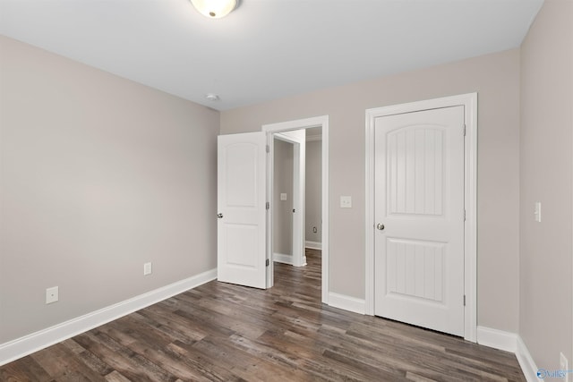 unfurnished bedroom featuring dark hardwood / wood-style floors