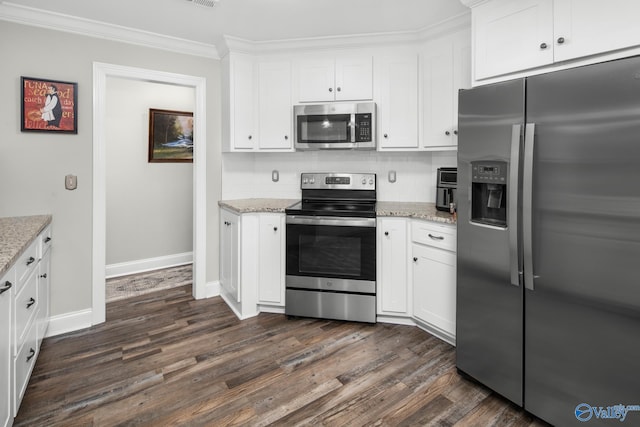 kitchen with light stone countertops, white cabinets, and appliances with stainless steel finishes