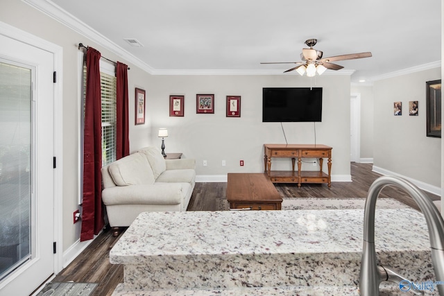 living room with crown molding, dark hardwood / wood-style floors, and ceiling fan