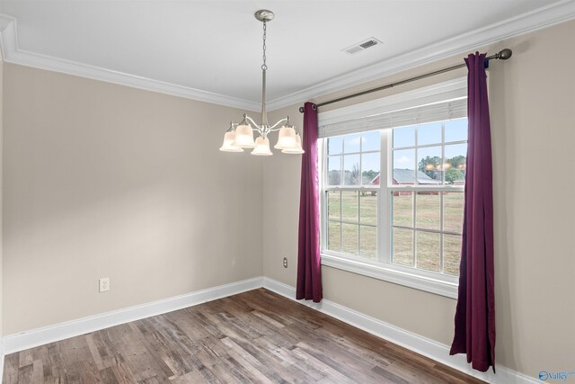 dining area featuring ornamental molding, wood-type flooring, and a notable chandelier