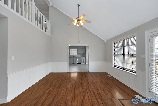 unfurnished living room with high vaulted ceiling, dark hardwood / wood-style floors, and ceiling fan