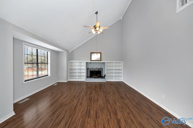 unfurnished living room featuring ceiling fan, high vaulted ceiling, ornamental molding, dark hardwood / wood-style flooring, and a brick fireplace