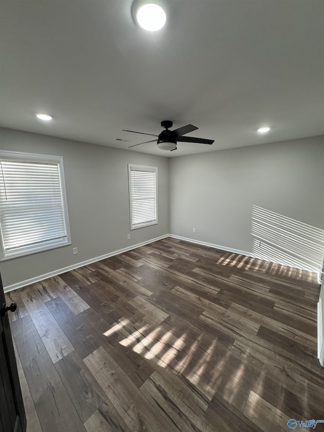 unfurnished room with a ceiling fan, recessed lighting, baseboards, and dark wood finished floors