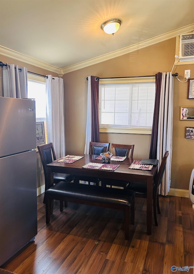 dining room featuring dark wood-style floors, baseboards, ornamental molding, and a wall mounted air conditioner