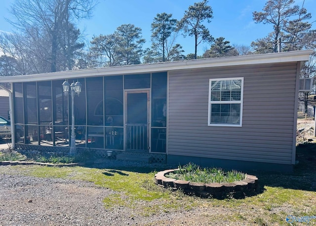 view of side of home featuring a sunroom