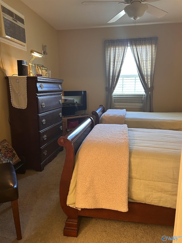 bedroom featuring carpet floors, ceiling fan, and a wall mounted AC