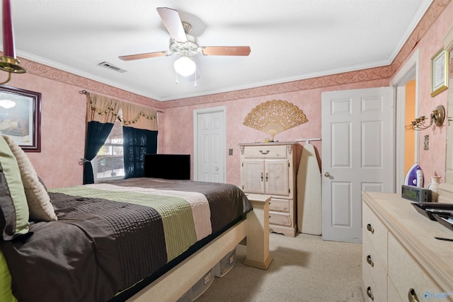 carpeted bedroom with ceiling fan and crown molding