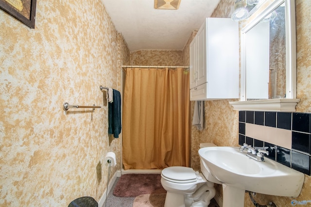 full bathroom featuring decorative backsplash, shower / bath combo, toilet, and sink