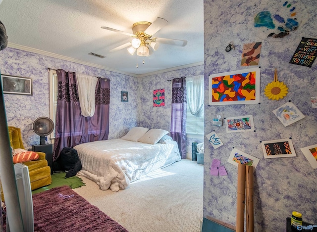 carpeted bedroom featuring a textured ceiling, ceiling fan, and crown molding